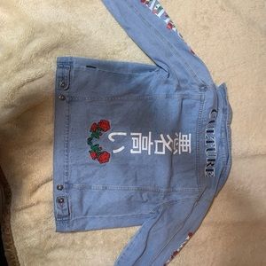 Jean jacket, roses on it.